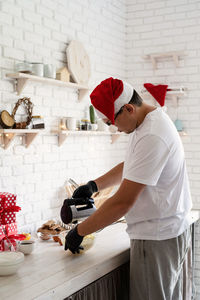 Side view of a man preparing food