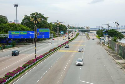 Cars on road in city against sky