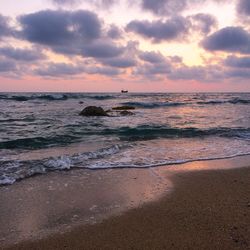 Scenic view of sea against cloudy sky