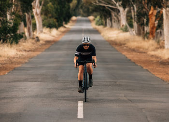 Man riding bicycle on road