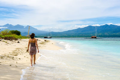 Woman standing on shore