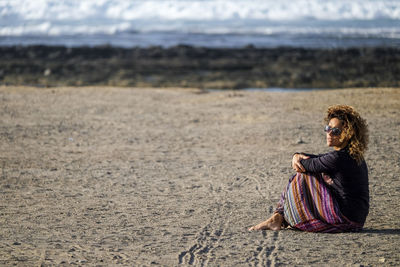 Mature adult woman sitting at beach