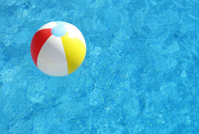 Close-up of beach ball floating on swimming pool