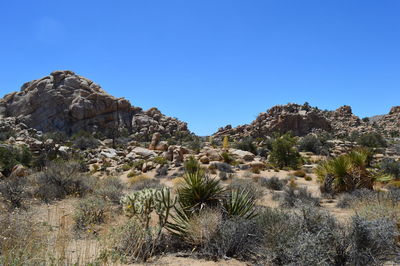 Rock formations against clear blue sky