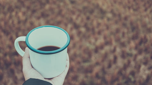 Person holding coffee cup