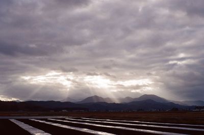 Road against storm clouds over landscape