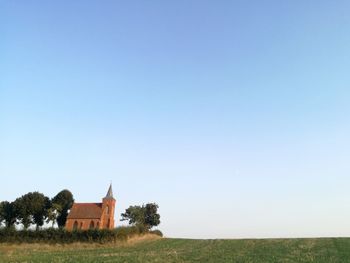 Temple on field against clear sky