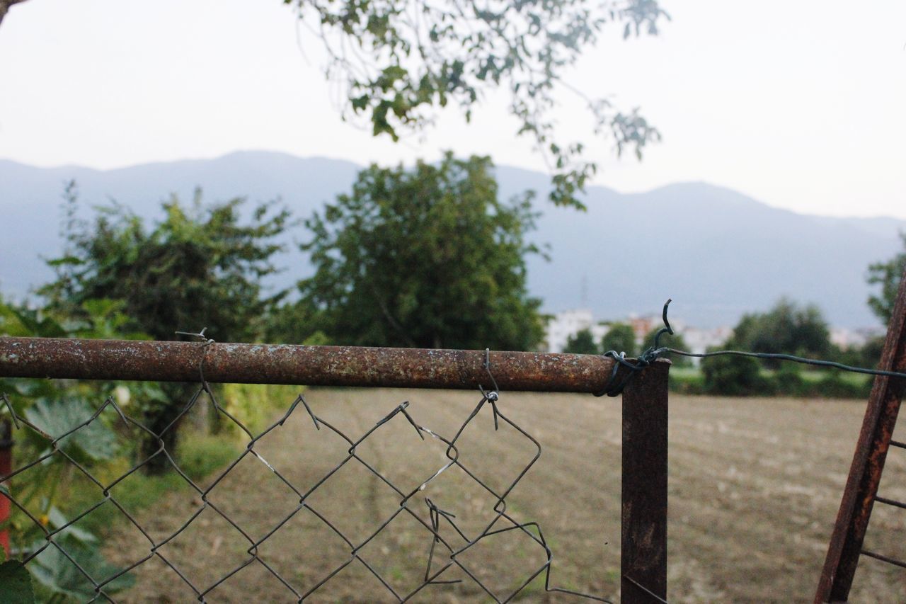 CLOSE-UP OF FENCE AGAINST SKY