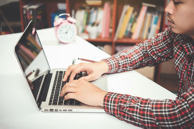 Low angle view of woman using laptop on table