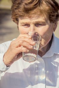 Close-up of woman drinking water