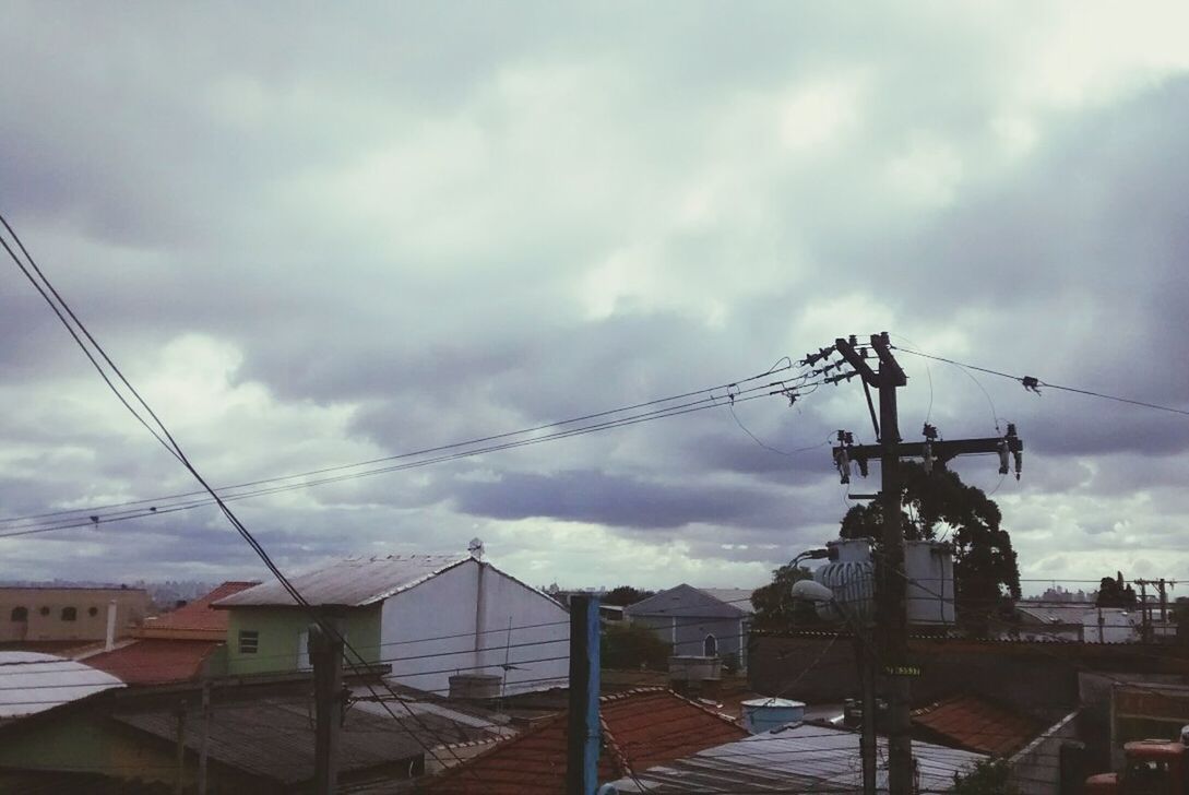 building exterior, sky, architecture, built structure, cloud - sky, cloudy, power line, electricity pylon, cable, electricity, house, weather, cloud, residential structure, power supply, low angle view, residential building, connection, fuel and power generation, overcast