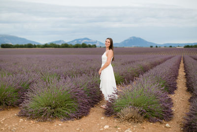 Full length of woman standing on land against sky