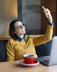 Woman using laptop while sitting on chair