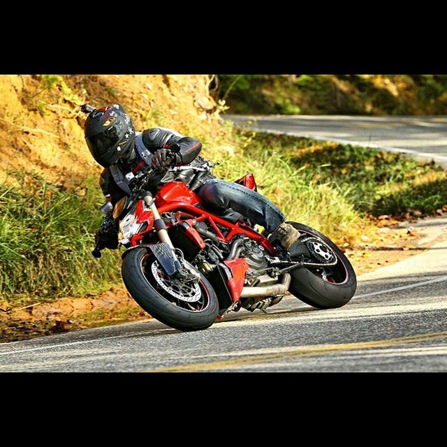 bicycle, transportation, land vehicle, mode of transport, riding, road, cycling, street, stationary, travel, day, motorcycle, outdoors, car, on the move, focus on foreground, helmet, sunlight