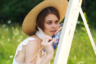 Portrait of young woman wearing hat