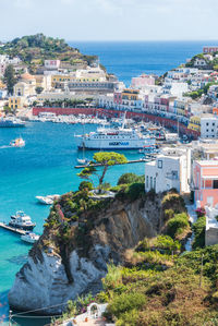 High angle view of townscape by sea against sky