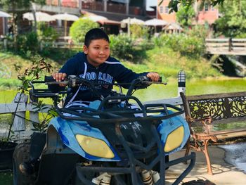 Portrait of boy sitting outdoors