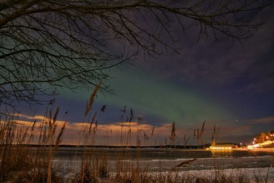 Scenic view of lake against northern lights