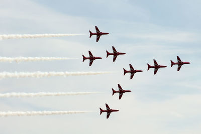 Low angle view of airshow in sky