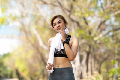 Full length of a young woman standing outdoors