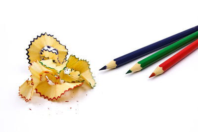 Close-up of colored pencils against white background