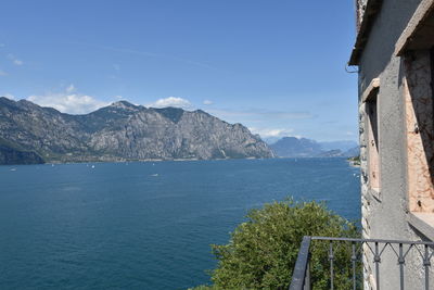 Scenic view of sea and mountains against sky