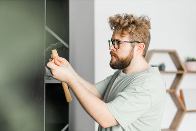 Side view of man using mobile phone