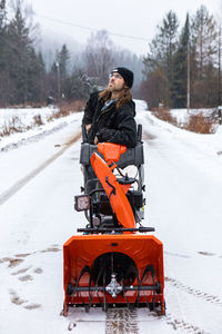 Man on snow covered road during winter