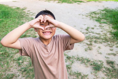 Portrait of smiling young man standing on land