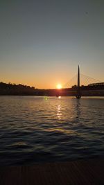 Silhouette of suspension bridge at sunset