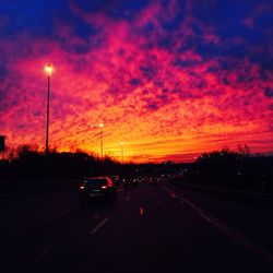 Cars on road at sunset