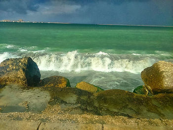 Close-up of beach against sky