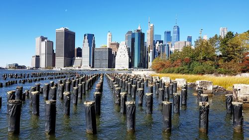 Lower manhattan from brooklyn bridge park - panoramic view of river and buildings against sky