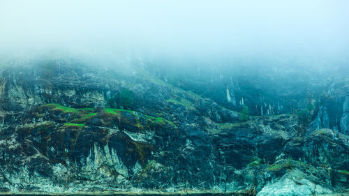 Scenic view of sea and mountains against sky