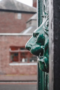 Close-up of statue against building