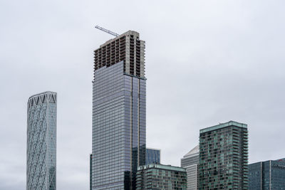 Low angle view of modern buildings in city against sky