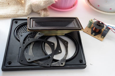 High angle view of old broken speaker on table