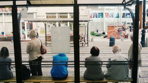 Rear view of people walking on street