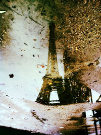 Reflection of building in puddle