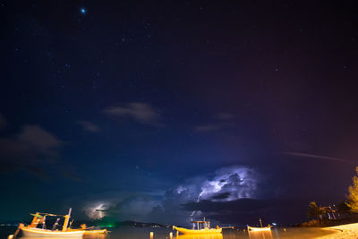 Low angle view of illuminated building against sky at night