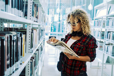 Full length of woman reading book