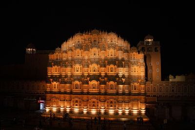 Illuminated building against sky at night