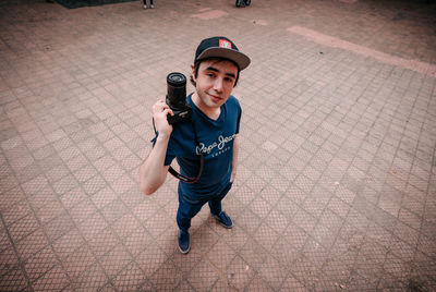 Full length portrait of boy standing against wall