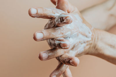 Close-up of woman washing hands