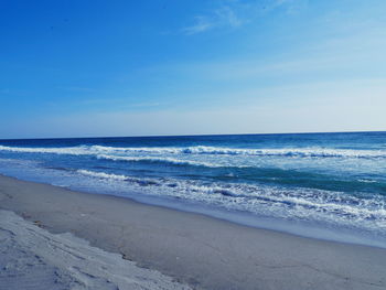 Scenic view of sea against blue sky