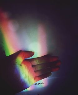 Close-up of hand holding multi colored lights