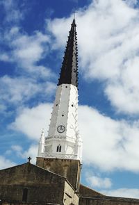 Low angle view of tower against cloudy sky