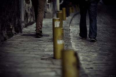 Low section of man walking on street