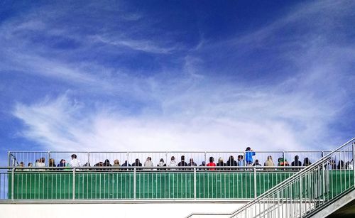 Railing against cloudy sky