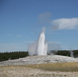 Scenic view of waterfall against sky